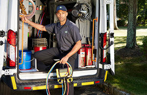 Service tech in front of service van