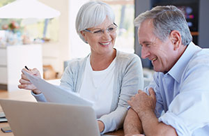 Couple sitting on sofa smiling