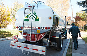 Service tech next to oil truck