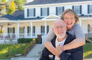 Couple smiling in front of house